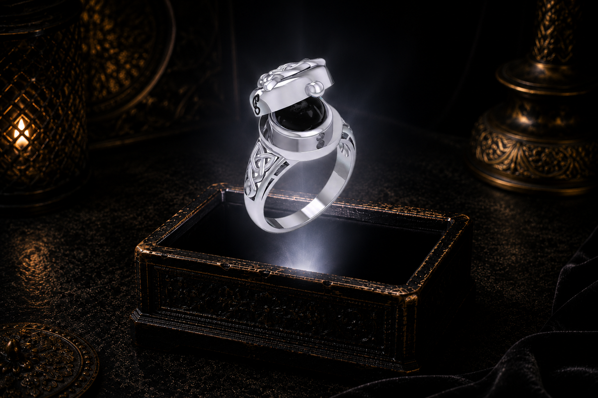 Sterling silver mystical Triquetra locket ring with black onyx gemstone and hidden cabochon stone illuminated above an antique jewelry box in a cinematic luxury setting
