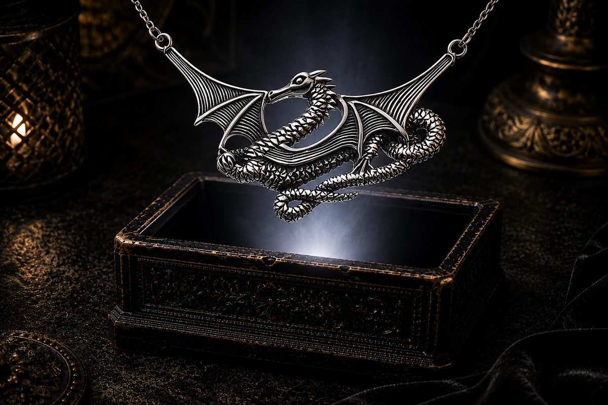 Mythical sterling silver sea dragon necklace displayed above an ornate jewelry box against a shadowed luxury backdrop