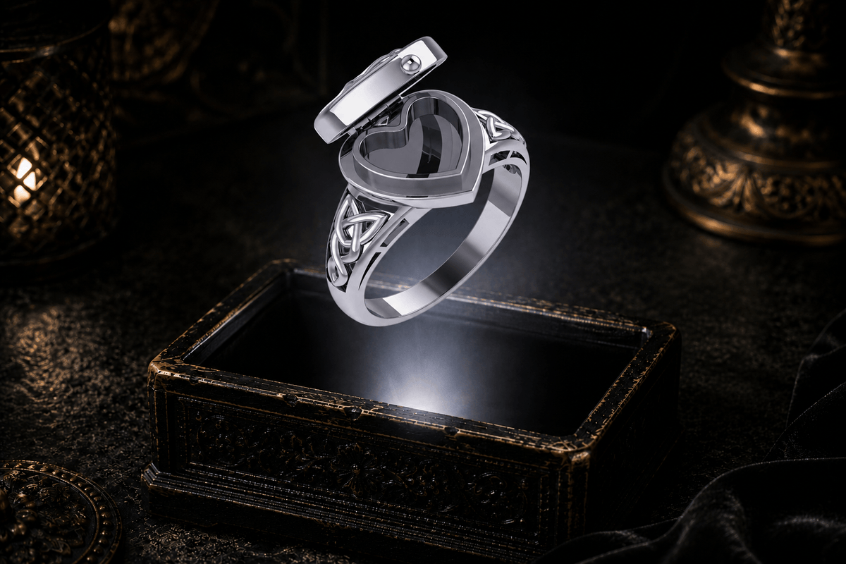 Open heart-shaped sterling silver poison ring showing its hidden compartment and Celtic knotwork shoulders