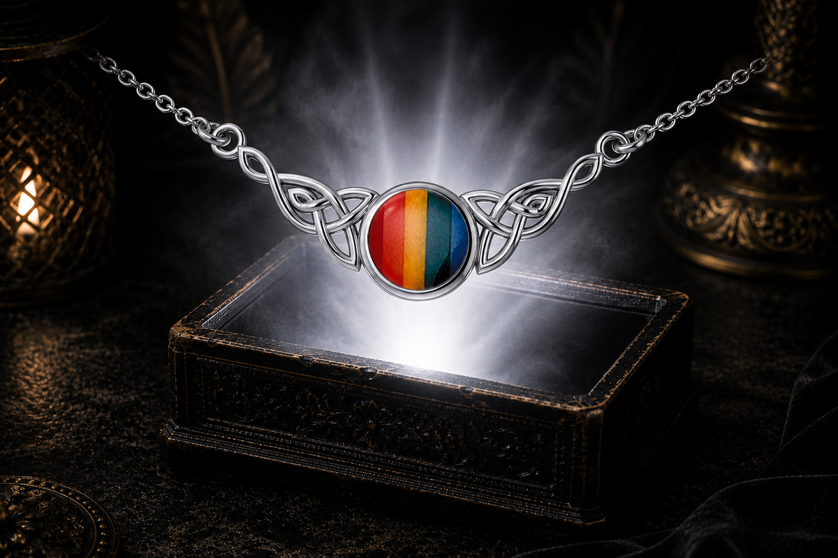 Rainbow Celtic knot sterling silver necklace floating above an ornate jewelry box with luminous mist and glowing light