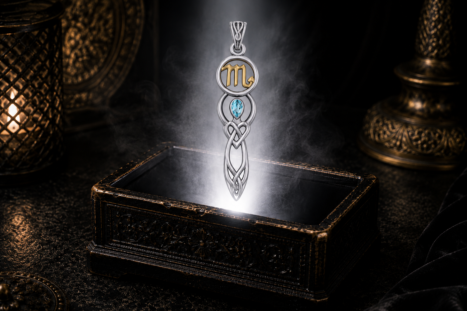 Sterling silver Scorpio zodiac goddess pendant with blue topaz and gold accents floating above an ornate jewelry box illuminated by glowing light in a dark luxury setting.