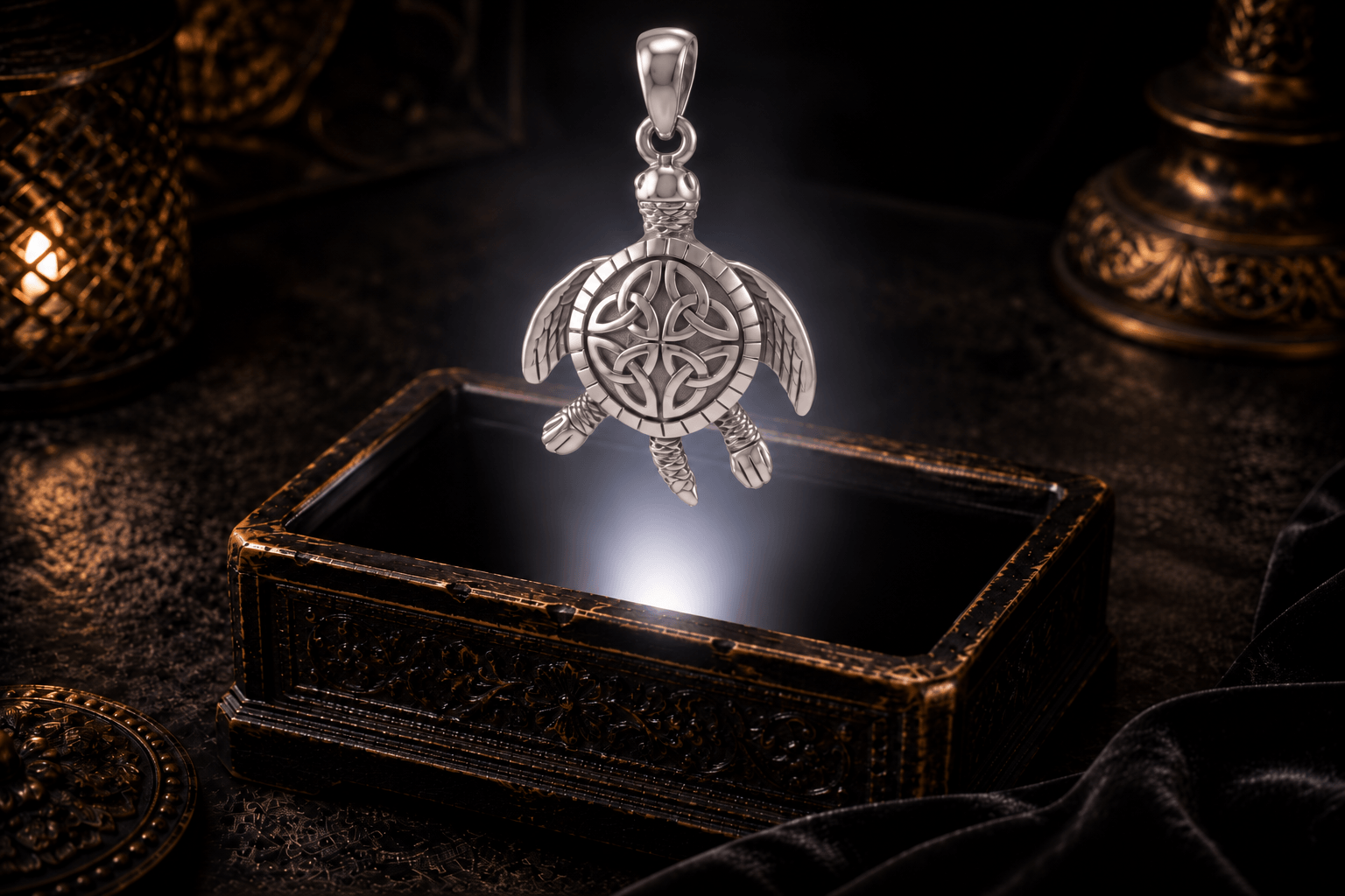 Celtic sea turtle pendant in 14K white gold with Trinity knot shell design above an antique jewelry box