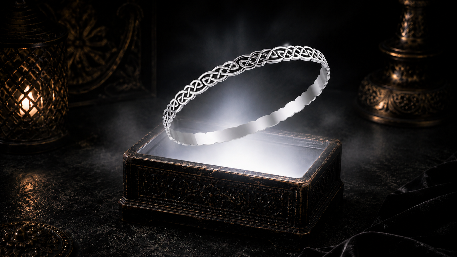 Slim sterling silver Celtic knot bangle bracelet floating above an ornate jewelry box illuminated by a soft white glow with warm candlelight accents in a dark luxury Celtic-inspired setting.