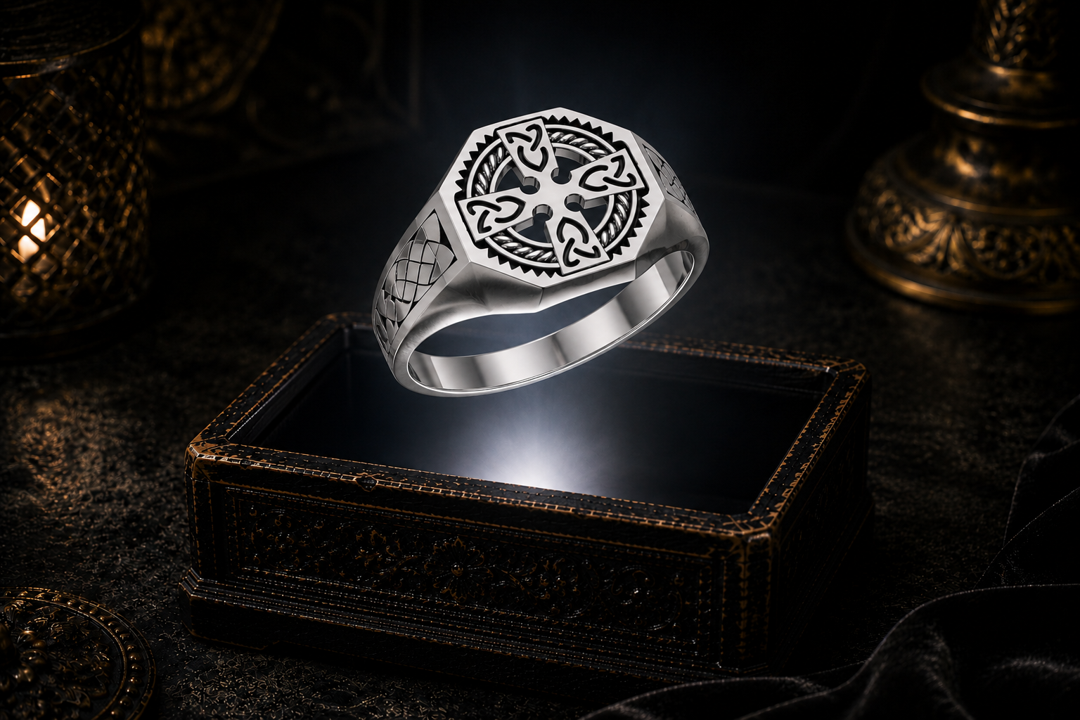 Sterling silver Celtic Cross signet ring with intricate Celtic knotwork displayed above an ornate dark jewelry box in a mystical gothic setting.