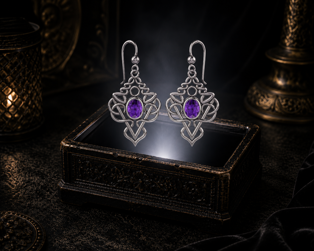 Sterling silver Celtic filigree knot drop earrings with amethyst gemstones floating above a glowing ornate jewelry box in a dark luxury setting