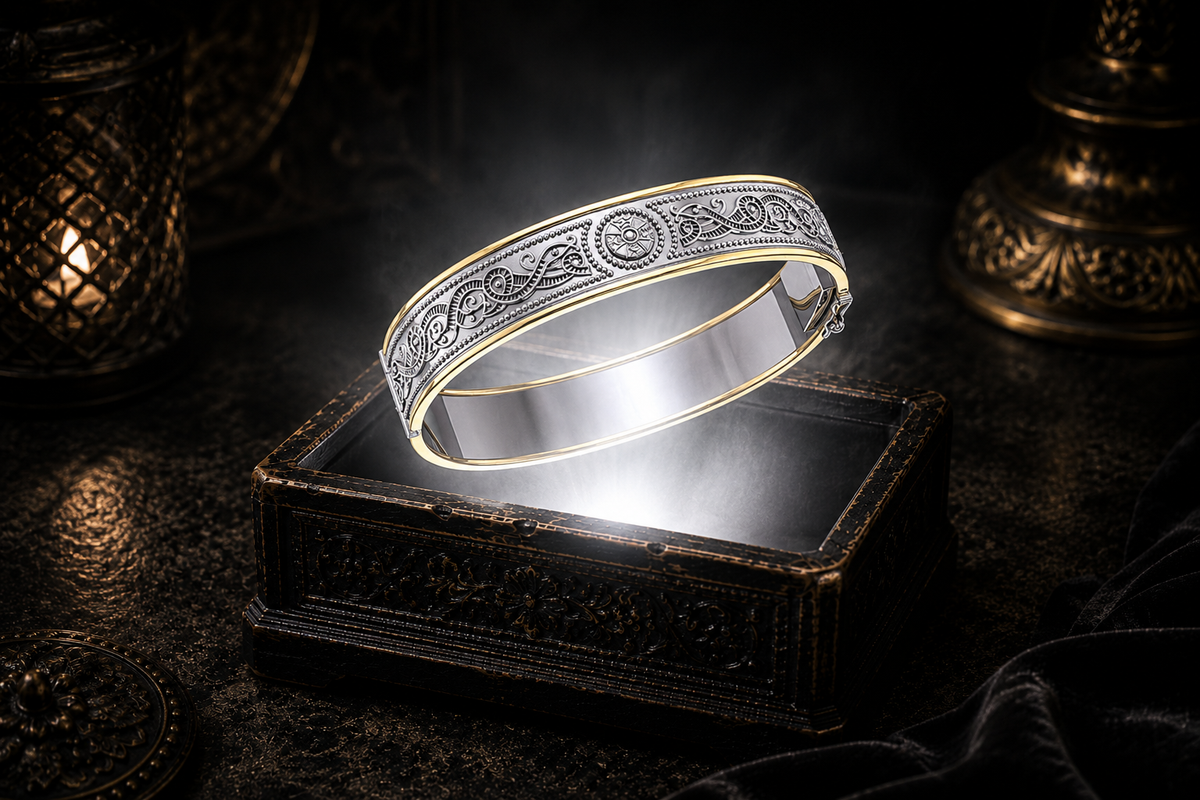 Sterling silver Celtic knotwork hinged bangle bracelet with 14K gold border accents floating above an ornate black jewelry box illuminated by soft white light in a dark luxury setting with refined Celtic elegance and cinematic atmosphere.