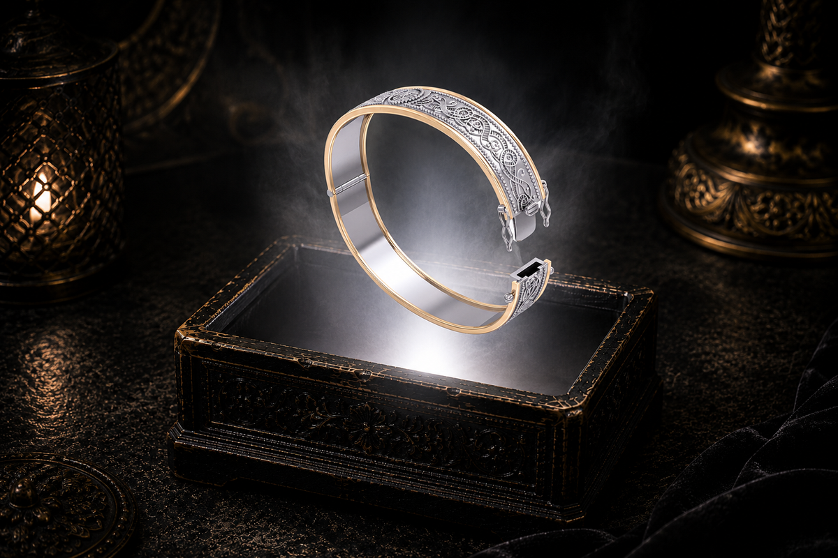 Sterling silver Celtic knotwork hinged bangle bracelet open with 14K gold border accents floating above an ornate black jewelry box illuminated by soft white light in a dark luxury setting with refined Celtic elegance and cinematic atmosphere.