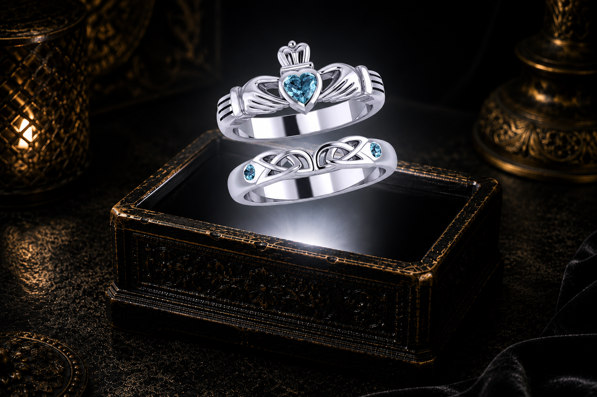 Sterling silver Claddagh ring set featuring Genuine Blue Topaz gemstones illuminated by warm candlelight above an antique jewelry chest.