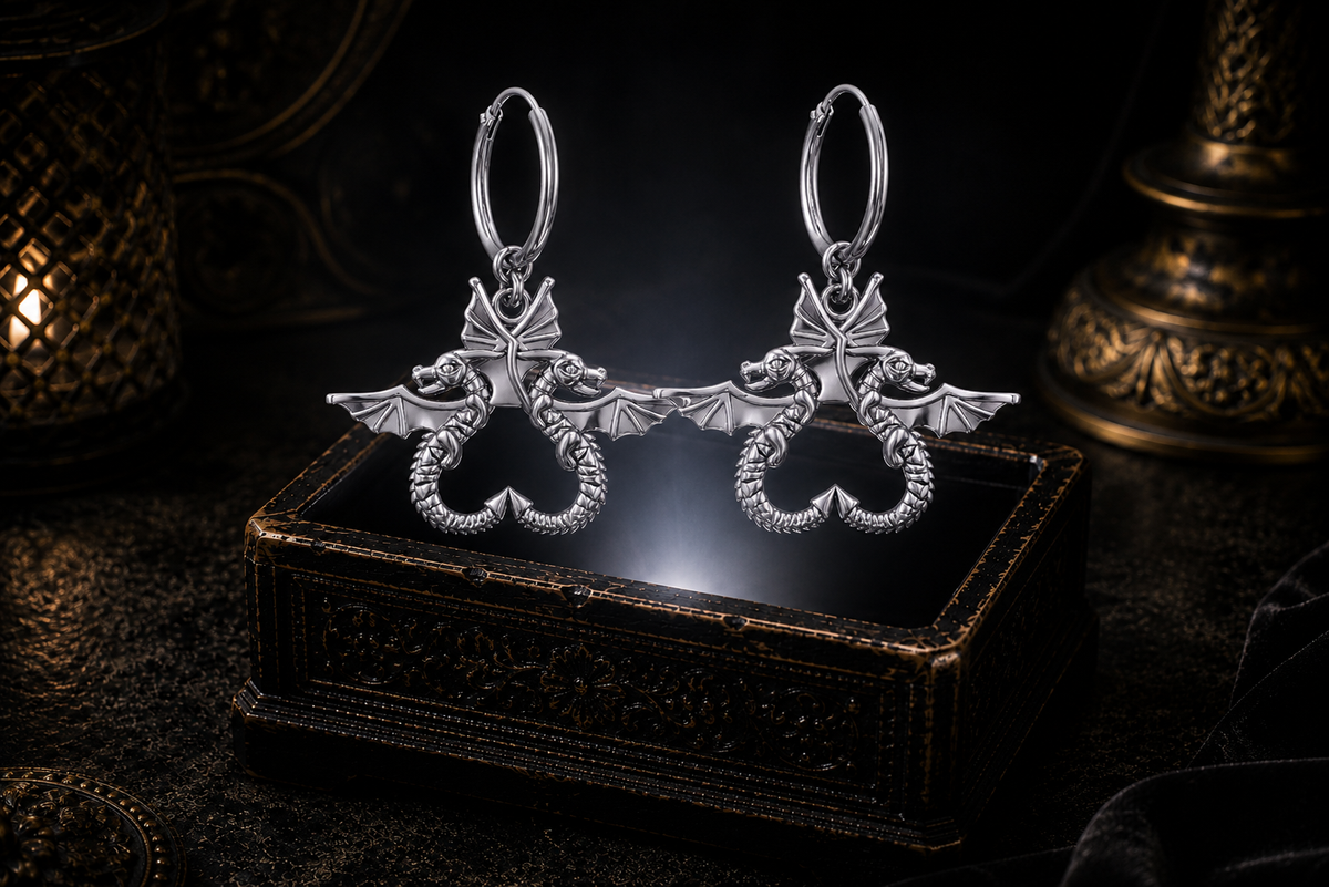 Sterling silver double dragon hoop earrings floating above a glowing ornate jewelry box in a dark luxury setting