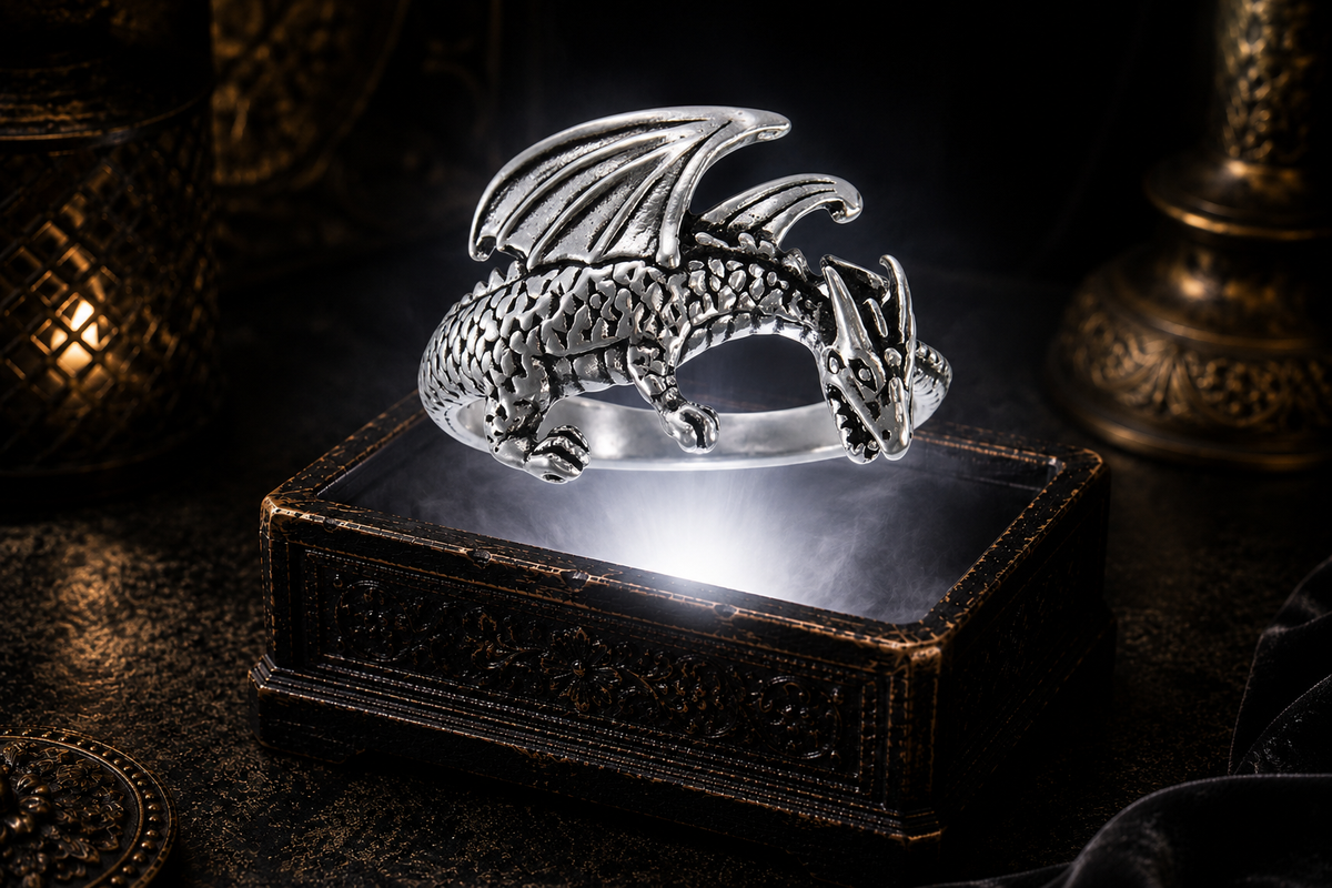Sterling silver medieval dragon wrap ring hovering above an antique jewelry box with white light, mist, candlelit shadows, and dark luxury scenery.
