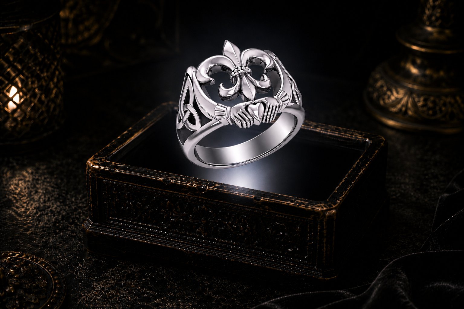 Sterling silver Fleur-de-Lis Claddagh ring with Celtic Trinity knot details displayed above an ornate dark jewelry box in a mystical gothic setting.