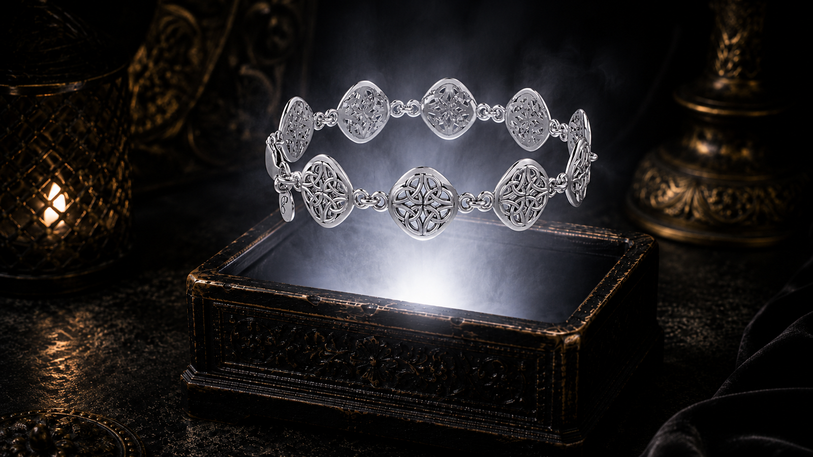 Sterling silver Four Point Knot bracelet suspended above a carved antique jewelry chest surrounded by luminous mist and elegant cinematic lighting.