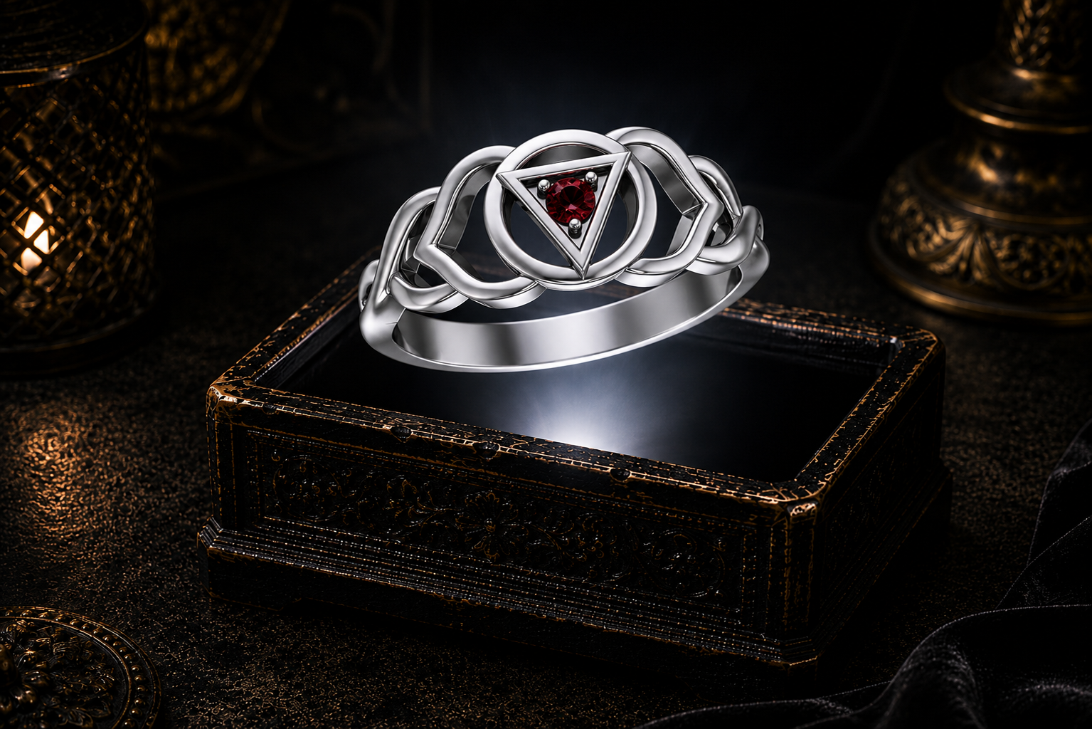 Sterling silver Third Eye chakra Celtic knot ring with garnet gemstone displayed above an ornate dark jewelry box in a mystical gothic setting.