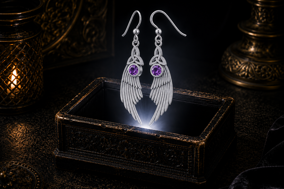 Sterling silver Celtic Trinity Knot angel wing earrings with amethyst gemstones floating above a glowing ornate jewelry box in a dark luxurious mystical setting with cinematic lighting