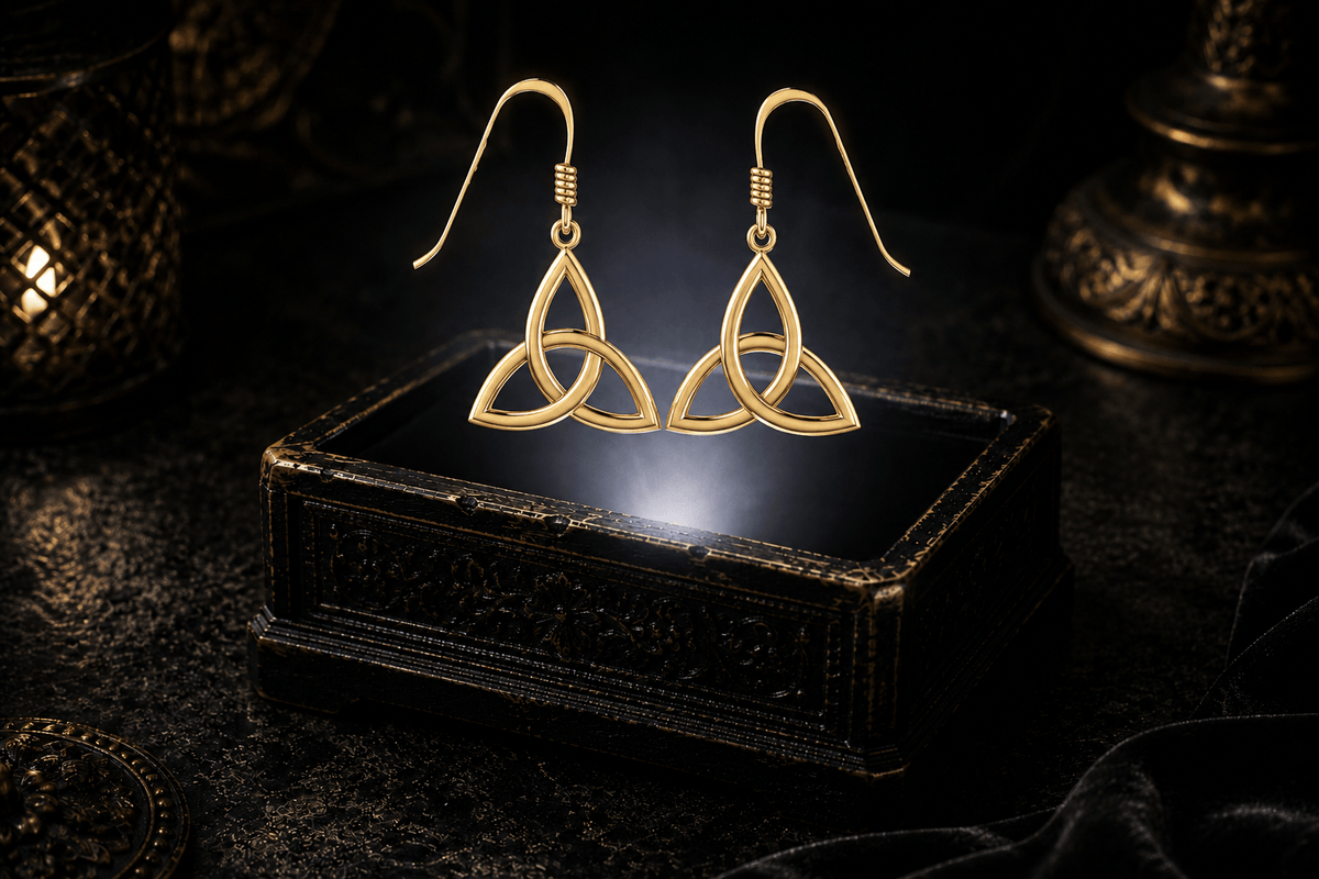 Pair of 14K yellow gold Trinity knot dangle earrings with openwork triquetra shapes and fishhook ear wires.
