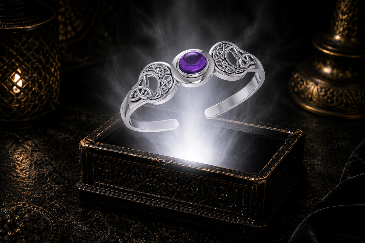 Sterling silver Triple Moon Celtic knot cuff bracelet with amethyst gemstone floating above an ornate jewelry box illuminated by soft white light in a dark luxury setting with mystical lunar symbolism and cinematic elegance.