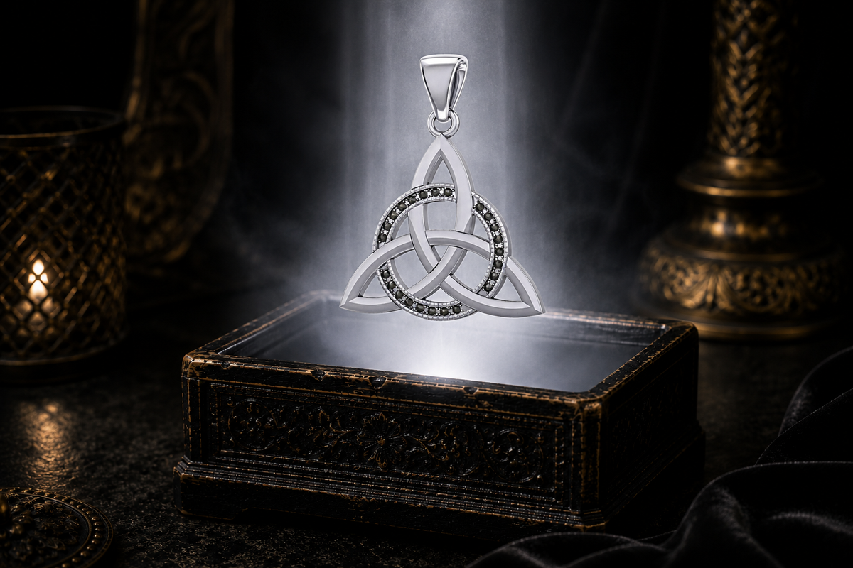 Sterling silver Triquetra entwined circle pendant with marcasite stones floating above an ornate jewelry box, illuminated by soft glowing light in a dark luxury setting.